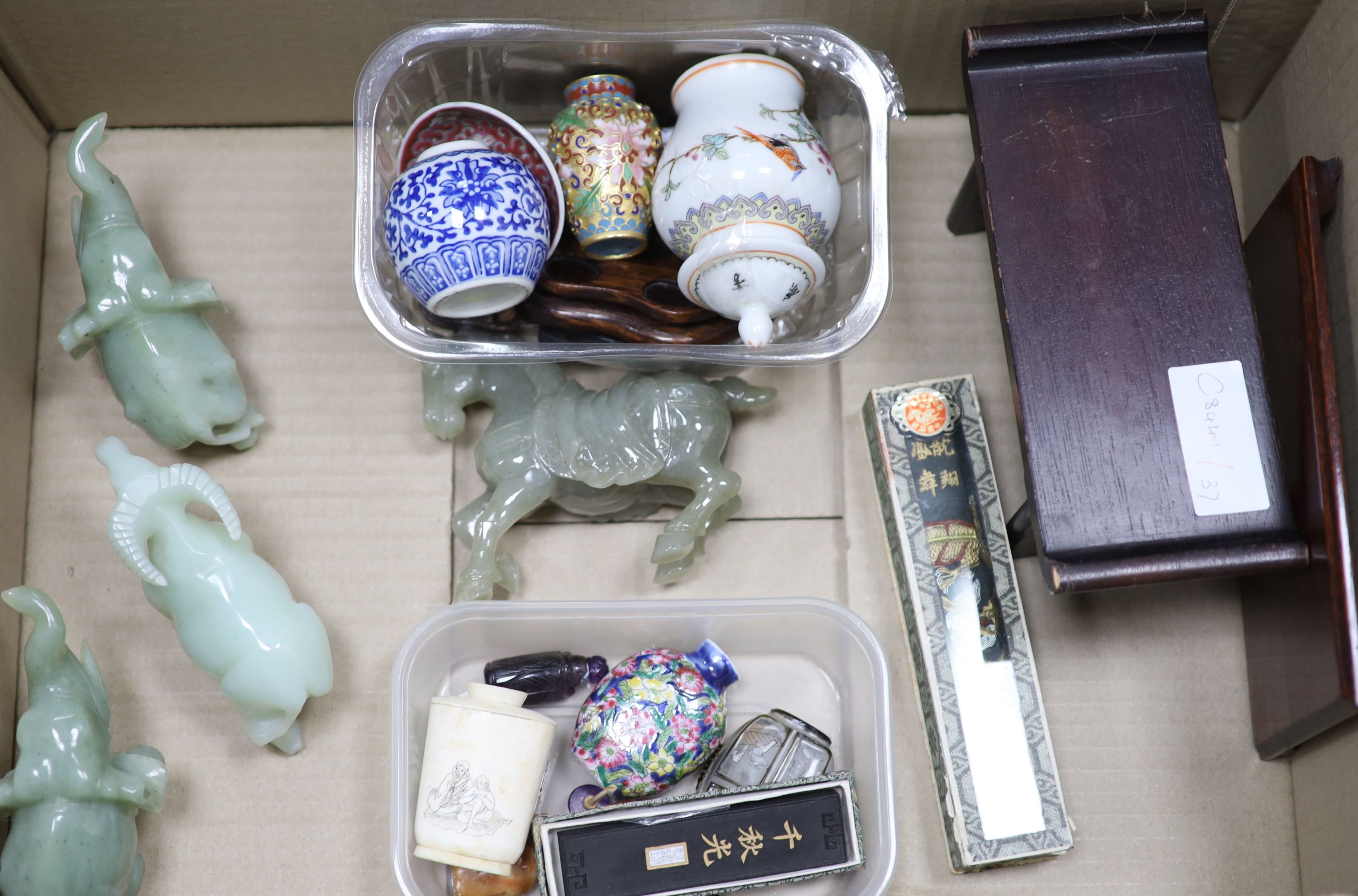 A collection of Chinese hardstone animals, collection of snuff bottles and small ornaments and two stands